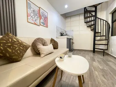 a living room with a couch and a table at Joes loft la70 laurles estadio Apt de 1Alcoba in Medellín