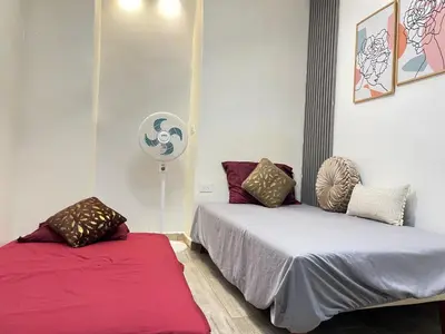 a bedroom with two beds and a fan at Joes loft la70 laurles estadio Apt de 1Alcoba in Medellín