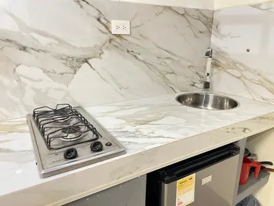 a kitchen counter with a stove and a sink at Joes loft la70 laurles estadio Apt de 1Alcoba in Medellín