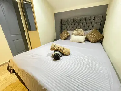 a bedroom with a large bed with a camera on it at Joes loft la70 laurles estadio Apt de 1Alcoba in Medellín