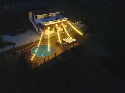 an overhead view of a pool at night with lights at Hermosa finca con vista a la piedra y embalse de Guatapé, con jacuzzi y piscina in Guatapé