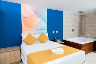 a bedroom with a bed and a bath tub at Bajo la luna hotel in Medellín