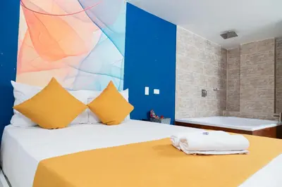 a bedroom with a bed with a colorful wall at Bajo la luna hotel in Medellín
