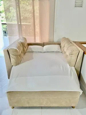 a large couch in a room with a window at Apto amplio 3 hab para familias y grupos Sabaneta in Sabaneta