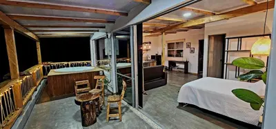 a hotel room with a bed and a balcony at Green mount in Medellín