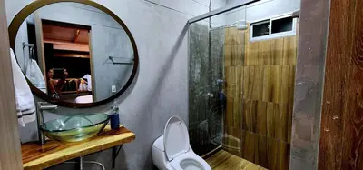a bathroom with a sink and a mirror and a toilet at Green mount in Medellín