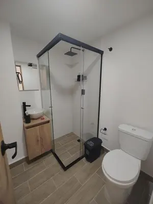 a bathroom with a shower and a toilet and a sink at Metro floresta acogedor apartaestudio in Medellín
