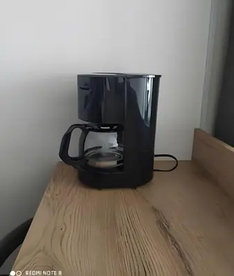 a black coffee pot sitting on top of a wooden table at Metro floresta acogedor apartaestudio in Medellín