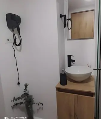 a bathroom with a sink and a mirror on the wall at Metro floresta acogedor apartaestudio in Medellín