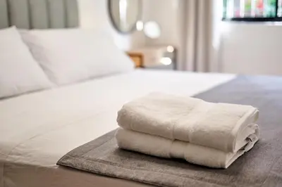a pile of towels sitting on top of a bed at Casa en Laureles- Excelente Ubicación! in Medellín
