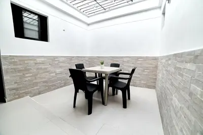a dining room with a table and black chairs at Casa en Laureles- Excelente Ubicación! in Medellín
