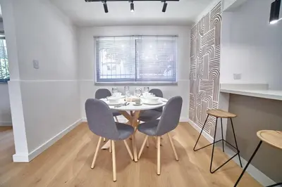 a dining room with a table and chairs at Casa en Laureles- Excelente Ubicación! in Medellín