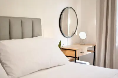 a bedroom with a bed with a mirror and a desk at Casa en Laureles- Excelente Ubicación! in Medellín