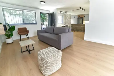 a living room with a gray couch and a stool at Casa en Laureles- Excelente Ubicación! in Medellín