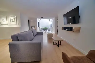a living room with a couch and a tv at Casa en Laureles- Excelente Ubicación! in Medellín