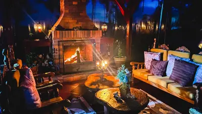 a living room with a couch and a fireplace at Ecohotel Salma in Villamaría
