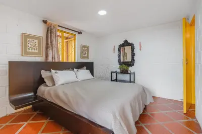 a bedroom with a large bed in a room at Ecohotel Salma in Villamaría