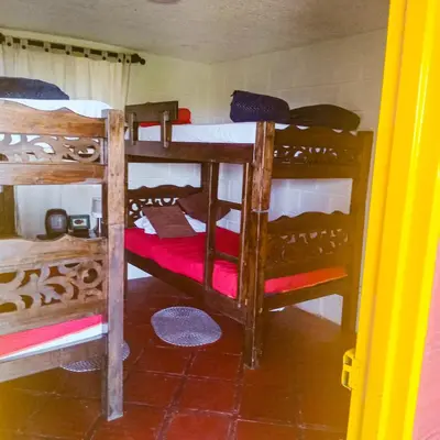 a room with three bunk beds in a house at Ecohotel Salma in Villamaría