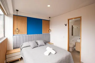a bedroom with a bed with two white towels on it at Apto con la mejor vista del Edificio in Medellín