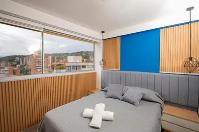 a bedroom with a bed with two white crosses on it at Apto con la mejor vista del Edificio in Medellín