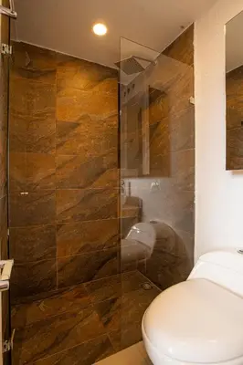 a bathroom with a toilet and a glass shower at Apto con la mejor vista del Edificio in Medellín