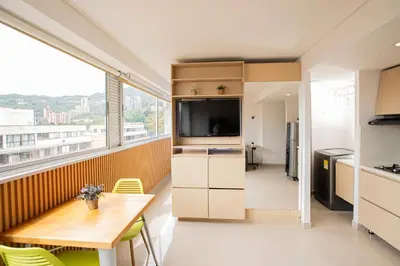 a kitchen with a table and a large window at Apto con la mejor vista del Edificio in Medellín