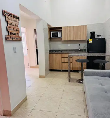 a kitchen with a couch and a table in a room at Apartamento Central La Candelaria Medellín in Medellín