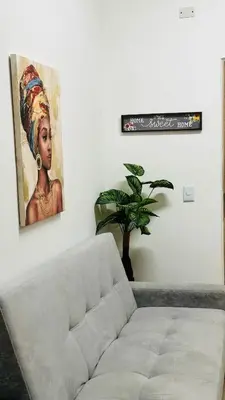 a living room with a couch and a painting on the wall at Apartamento Central La Candelaria Medellín in Medellín