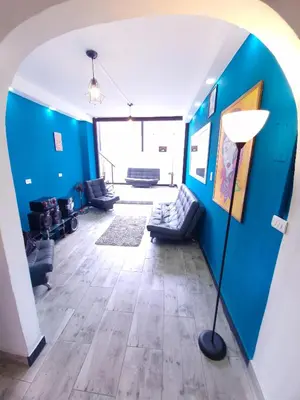 a living room with blue walls and a floor lamp at 5 Bedrooms Apartment with Jacuzzi at Lleras park in Medellín