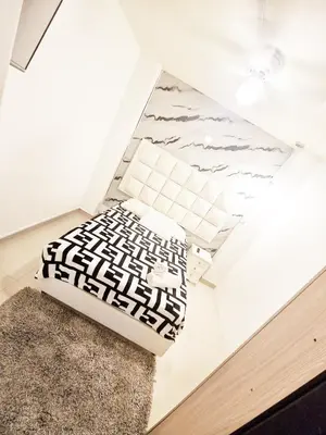a room with a bed and a rug on the floor at 5 Bedrooms Apartment with Jacuzzi at Lleras park in Medellín
