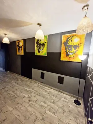 a room with paintings on the wall and a lamp at 5 Bedrooms Apartment with Jacuzzi at Lleras park in Medellín