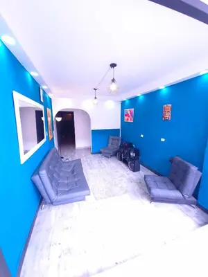 a living room with couches and a blue wall at 5 Bedrooms Apartment with Jacuzzi at Lleras park in Medellín