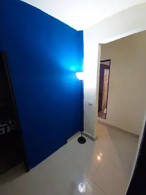 a hallway with a blue wall and a lamp at 5 Bedrooms Apartment with Jacuzzi at Lleras park in Medellín