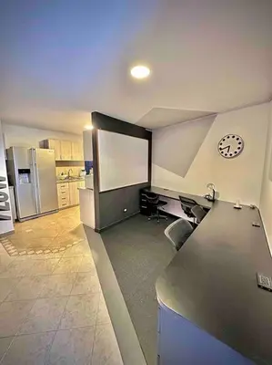 a large kitchen with a desk and a chalkboard at Colonial Charm House in Medellín