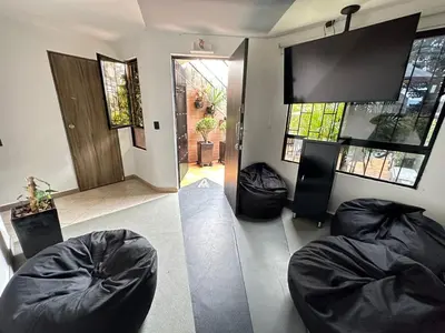 a living room with two bean bag chairs and a television at Colonial Charm House in Medellín