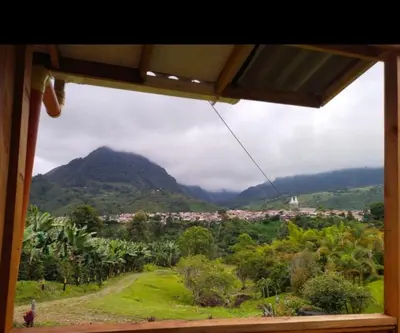 a view of a mountain from a window at Cabañas Lucerito Turpial in Jardin