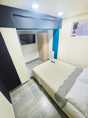 a small room with a bed and a small door at Urban 8 Bedrooms Apartment at Poblado in Medellín