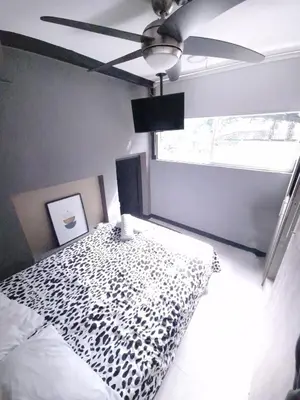a bedroom with a bed and a ceiling fan at Urban 8 Bedrooms Apartment at Poblado in Medellín