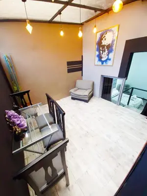 a living room with a table and chairs and a couch at Urban 8 Bedrooms Apartment at Poblado in Medellín