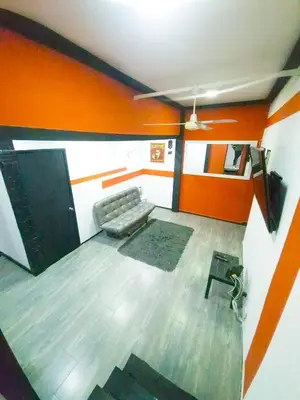 a living room with a couch and orange walls at Urban 8 Bedrooms Apartment at Poblado in Medellín