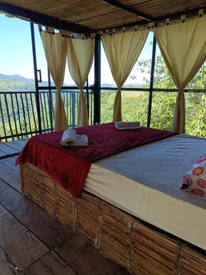 a bed in a room with a view at Cabaña la Antiguita in San Luis