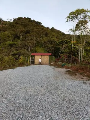 a person sitting in a shed on a gravel road at Cabaña la Antiguita in San Luis