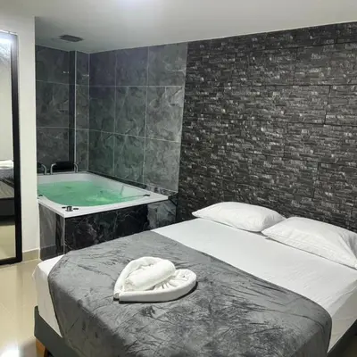 a bedroom with a bed and a bath tub at Format one in Medellín