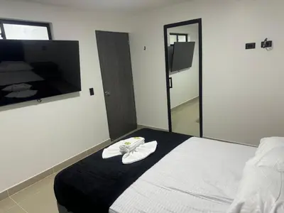 a bedroom with a bed with a towel on it at Format one in Medellín