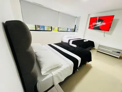 a bedroom with a bed and a chair in it at Format one in Medellín