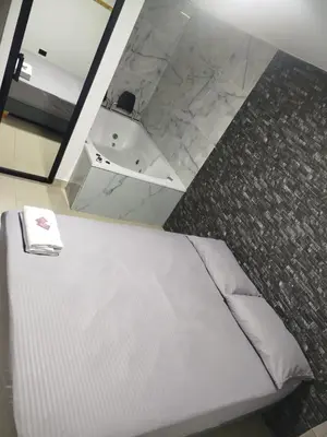 a bedroom with a white bed and a sink at Format one in Medellín