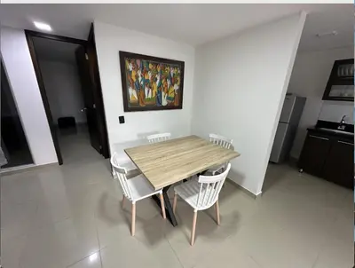 a dining room table and chairs in a room at Acogedor apartamento en Laureles in Medellín