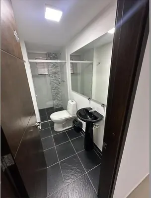 a bathroom with a toilet and a sink at Acogedor apartamento en Laureles in Medellín