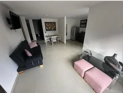 a living room with a couch and a table at Acogedor apartamento en Laureles in Medellín