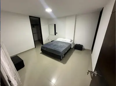 a bedroom with a bed in a small room at Acogedor apartamento en Laureles in Medellín